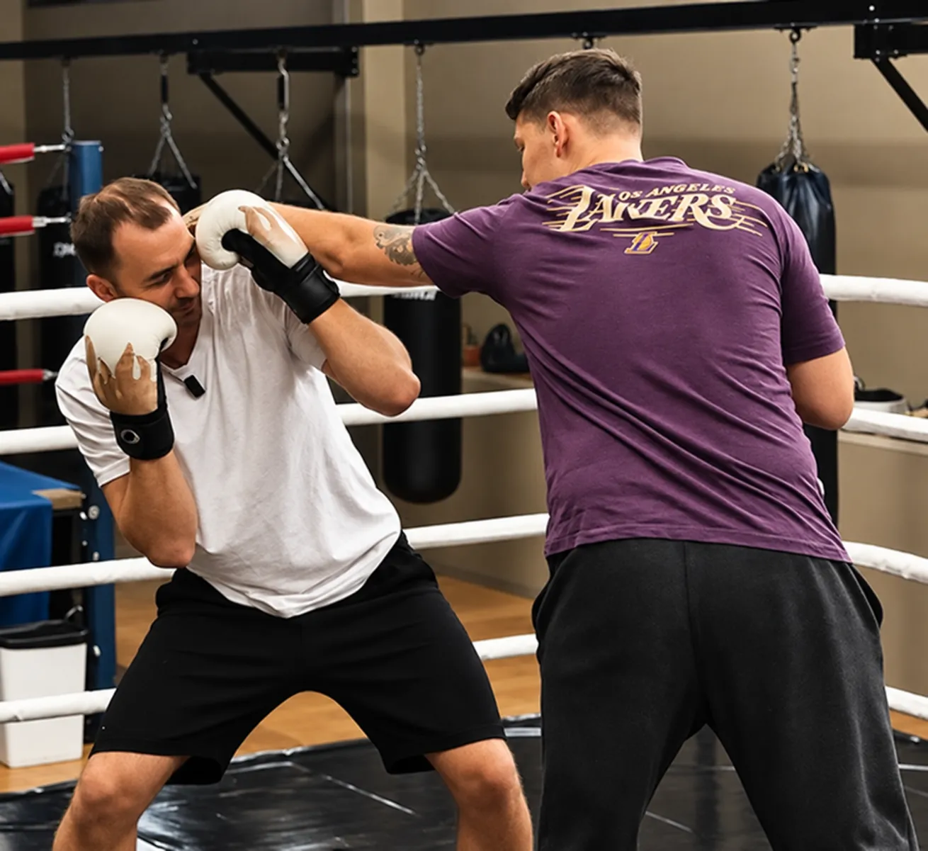 Ilya holds pads for a client in the ring